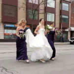 Bride crossing the street with brides maids