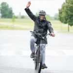 Bike for health participant raises arm