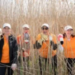 4 woman with hand puppets in tall grass